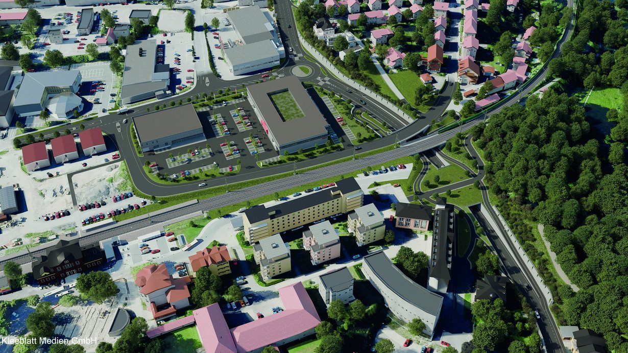 Eine 3D-Visualisierung der Maßnahme als Luftbild. Ein neuer Kreisverkehr, die Unterführung unter der Bahn und eine breite Grünbrücke mit Fuß- und Radwegen sind erkennbar. 