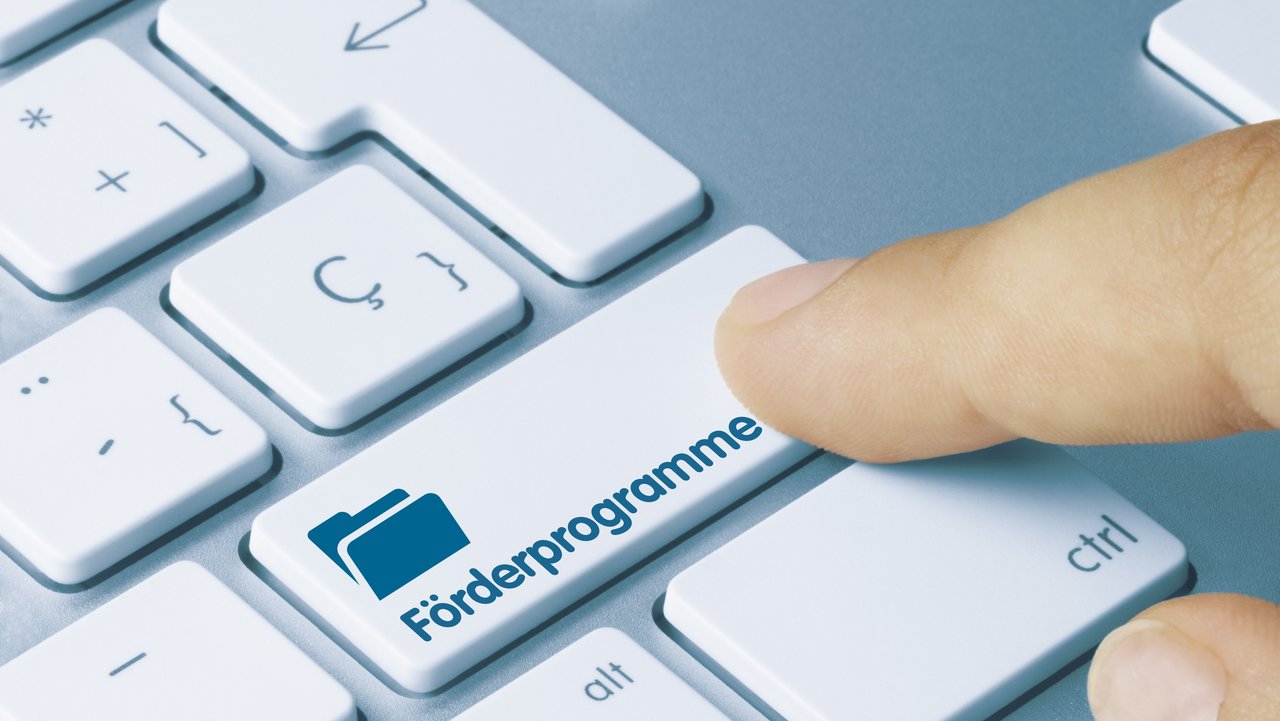 Förderprogramme Eine Tastatur mit Aufschrift Förderprogramme