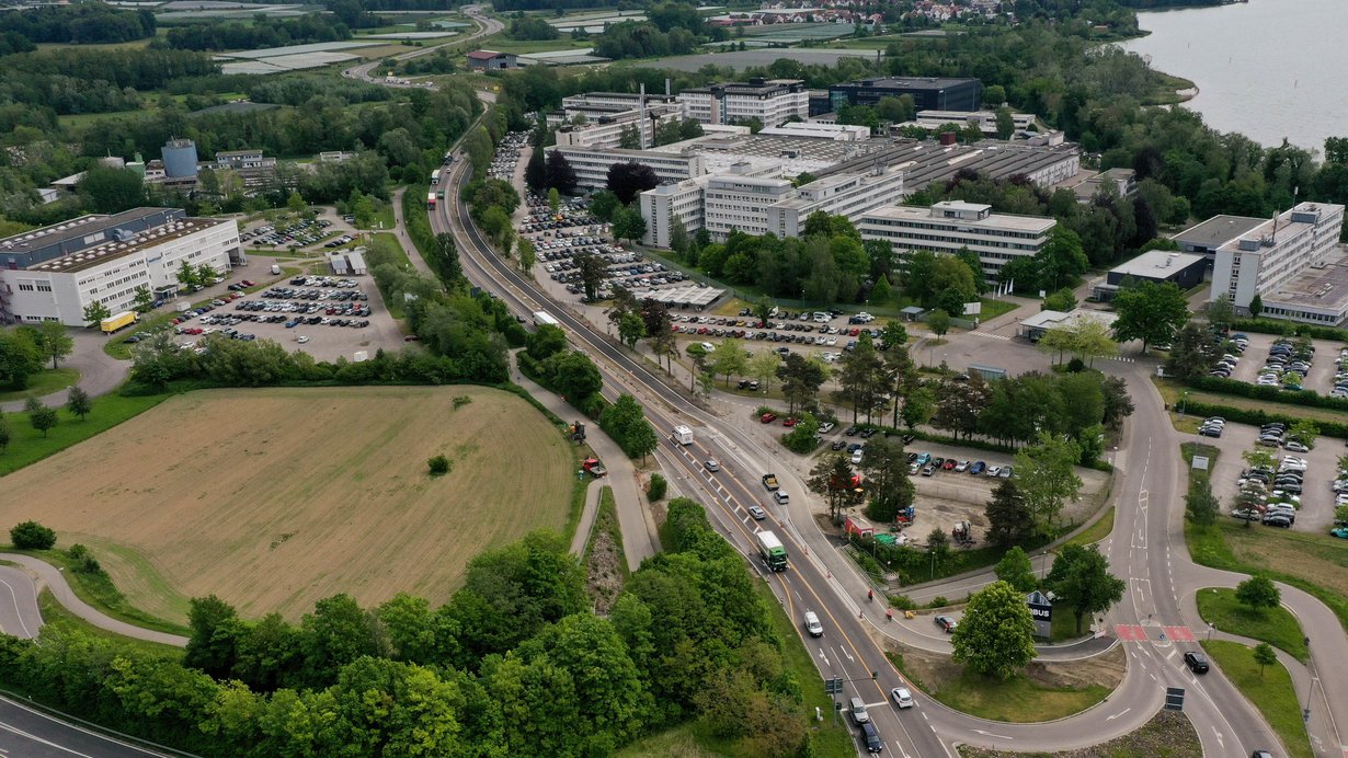 Eine Luftaufname, die eine stark befahrene Straße und einen breiten, neu ausgebauten Radweg zeigt.