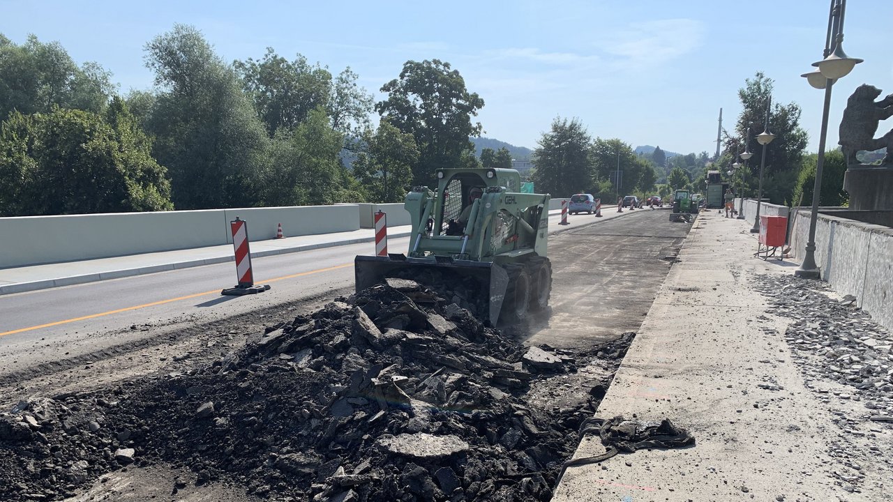 Das Bild zeigt die Gallusbrücke; eine Planierraupe reißt gerade die Asphaltfahrbahn auf