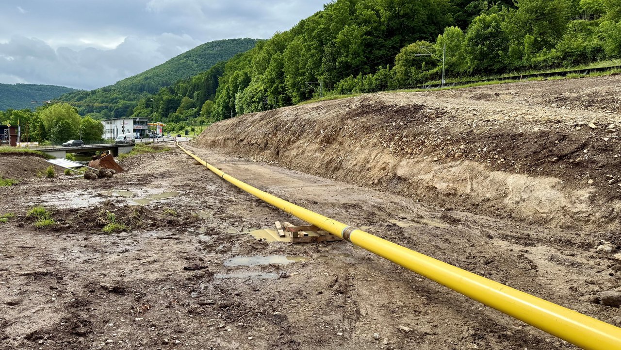 Das Foto zeigt eine gelbe Gasleitung die sich über mehrere Meter über eine Baustelle erstreckt